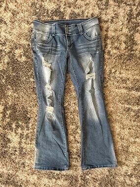 Distressed Light Blue Flared Jeans with Ripped Detail